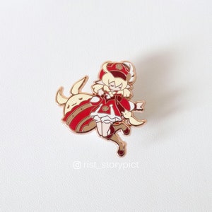 May include: A gold-tone enamel pin featuring a cartoon character with blonde hair wearing a red and white outfit and a crown. The character is riding a white and gold animal with a red and gold body.