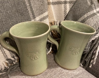 Pair of celadon glaze mugs with elephant motif