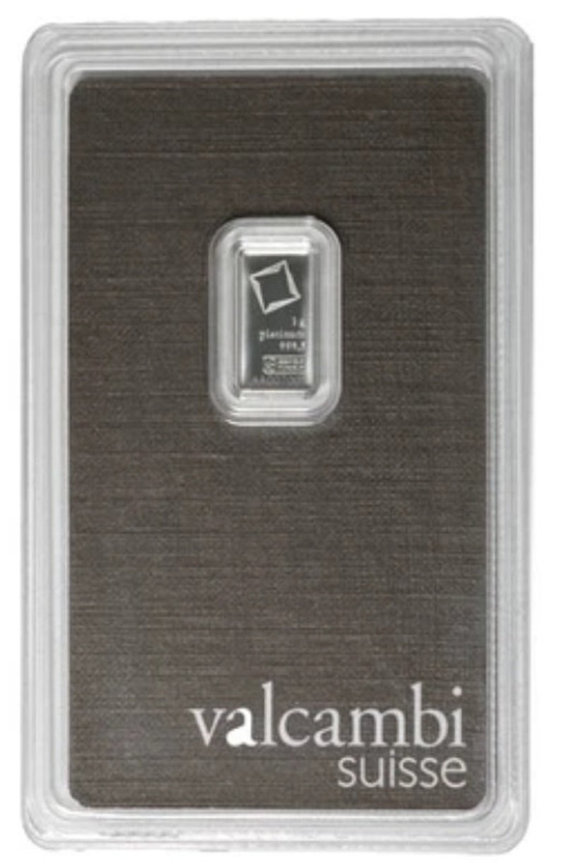 May include: A platinum bar encased in a clear plastic holder. The bar is rectangular with a small logo and text. The holder sits on a dark gray background with the words "valcambi suisse" printed in white.