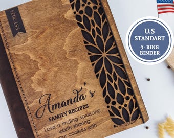 May include: Wooden recipe binder with a dark brown leather spine. The cover is engraved with "Amanda's Family Recipes" and a decorative floral design. Includes the text "Love is finding someone worth sharing your cookies with."