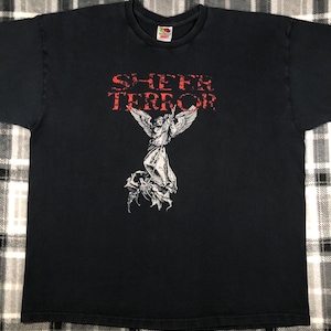 May include: Black t-shirt with a white graphic of an angel with wings, holding a sword, standing over a demon. The text "SHEER TERROR" is printed in red above the graphic.