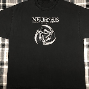 May include: Black t-shirt with a white graphic of the band "Neurosis" and a symbol with three stylized scythes.