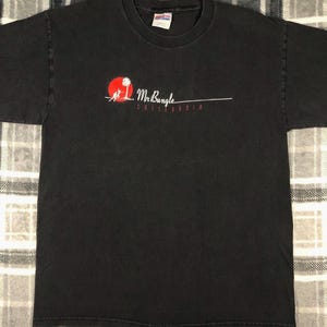May include: Black t-shirt with a red and white graphic of a palm tree and the text "Mr. Bungle California".
