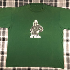 May include: Green t-shirt with a black and white image of Ozzy Osbourne and the text "Ozzy Is God".