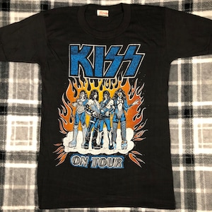 May include: Black t-shirt with a graphic of the band KISS in flames, with the text "KISS ON TOUR".