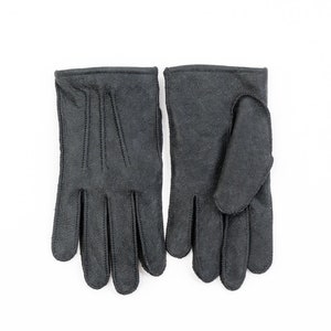 May include: A pair of black leather gloves with a stitched design.