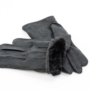 May include: A pair of black leather gloves with a faux fur cuff. The gloves are folded in half and the fur cuff is visible.