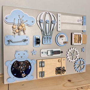 Wall mount busy board for baby with Wooden montessori parts and sensory activities on board. Busy board for 1 year old