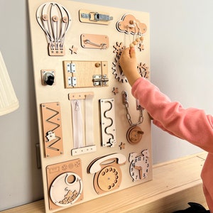 Delve into the world of our Extra Large Montessori Sensory Board, the ultimate 1st Birthday Gift! This Busy Board engages toddlers in interactive play, promoting developmental milestones. Invest in educational fun that enhances motor skills