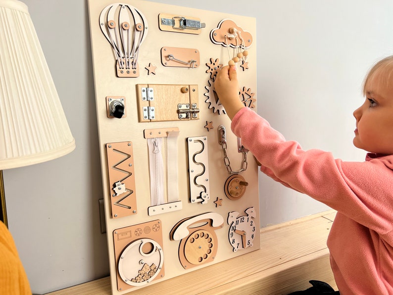 Delve into the world of our Extra Large Montessori Sensory Board, the ultimate 1st Birthday Gift! This Busy Board engages toddlers in interactive play, promoting developmental milestones. Invest in educational fun that enhances motor skills