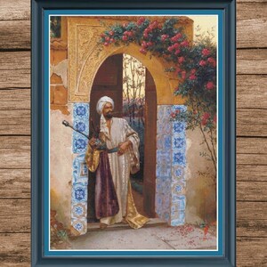 May include: A framed print of an orientalist painting. The artwork depicts a man in traditional attire holding a staff, standing in an archway adorned with roses. The archway is decorated with blue and white tiles.
