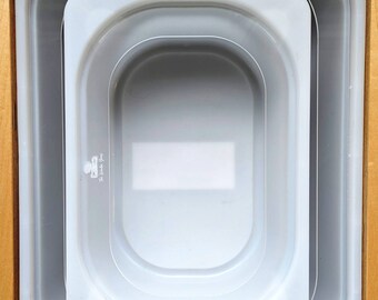 May include: A set of three white nesting bowls with rounded edges. The bowls are made of a smooth, glossy material and are perfect for serving snacks, dips, or desserts.