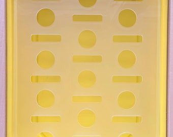 May include: A yellow wooden frame with a clear plastic insert. The insert has a grid pattern of circles and rectangles. The text "The Wonder Years" is printed in white on the insert.