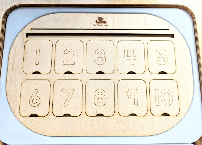 May include: A wooden box with a slot at the top and ten numbered compartments. The compartments are labeled with the numbers 1 through 10.