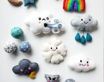 May include: A set of felt weather-themed ornaments with cute faces. The set includes a sun, a rainbow, a cloud with wind, a cloud with rain, a cloud with lightning, a cloud with snow, a star, a crescent moon, and a tornado.