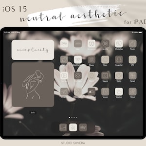 May include: A screenshot of an iPad displaying a neutral aesthetic iOS 15 home screen with a brown background and a floral pattern. The home screen is organized with a grid of app icons, each with a simple, minimalist design. The text "simplicity" is displayed in a large font at the top of the screen. The text "STUDIO SHVERA" is displayed at the bottom of the screen.
