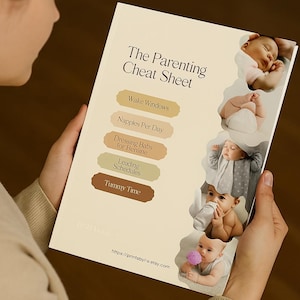 May include: A cream-colored "The Parenting Cheat Sheet" guide held by a person. The guide features sections on baby care, including "Wake Windows" and "Tummy Time," with images of babies. The Etsy shop URL is visible at the bottom.