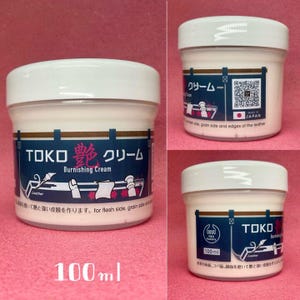 May include: A white jar of leather burnishing cream with a black and red label. The label says "TOKO Burnishing Cream" and has a Japanese character on it. The jar is 100 ml.