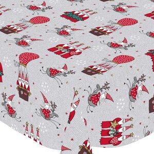 May include: A grey and white tablecloth with a repeating pattern of gnomes in hot air balloons, riding reindeer, and standing on rooftops. The gnomes are wearing red hats and have white beards. The tablecloth has a festive Christmas theme.