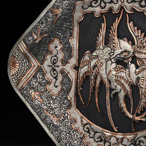 May include: A silver and copper tray with an intricate design of birds and clouds. The tray is square and has a black background.