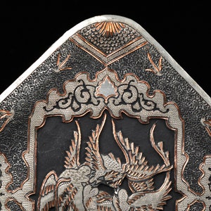 May include: A silver and copper tray with intricate floral and bird designs. The tray is decorated with a raised, textured pattern.