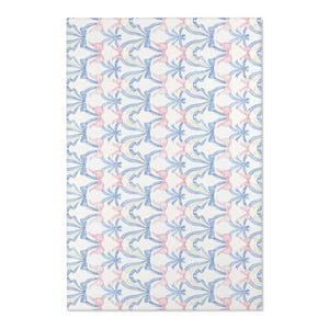 May include: A rectangular rug with a repeating pattern of blue and yellow ribbons and pink bows on a white background. The design is symmetrical and creates a delicate, decorative effect. The rug is suitable for a bedroom or living room.