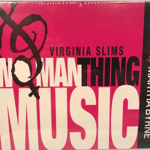 May include: A pink CD case with the text "Virginia Slims Womanthing Music" in white and black lettering. The case also has a black treble clef symbol. The text "Volume 1: Pop Martha Byrne" is printed on the right side of the case.