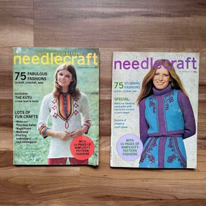May include: Two vintage Good Housekeeping Needlecraft magazines featuring colorful knitted clothing designs. The Spring/Summer 1973 issue features a woman wearing a red, orange, and yellow sweater with geometric patterns. The Fall/Winter 1973-74 issue features a woman wearing a blue and purple sweater with floral embroidery.