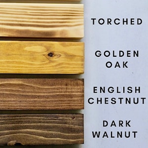 May include: Six wood samples in different shades of brown, from light to dark. The samples are labeled with the following wood types: Natural, Torched, Golden Oak, English Chestnut, Dark Walnut, and Ebony.