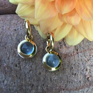Small hoop earrings with handmade aquamarine pendants made of 750 yellow and white gold. 1550 euros
