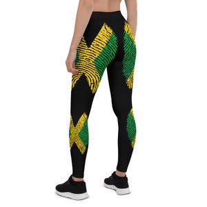Könnte beinhalten: Schwarze Leggings mit einem sich wiederholenden Muster aus gelben, grünen und schwarzen Fingerabdrücken.