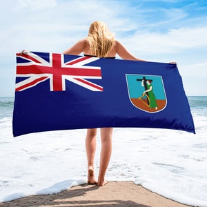 May include: A blue beach towel with the flag of the British Virgin Islands. The flag features a Union Jack in the upper left corner and the coat of arms of the British Virgin Islands in the lower right corner.