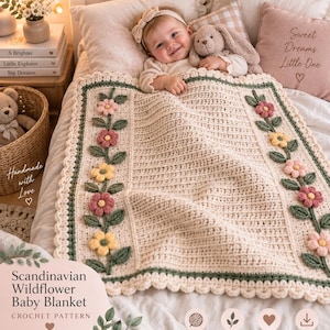 May include: A cream-coloured crochet baby blanket featuring a textured ribbed centre and two vertical borders decorated with three-dimensional pink and yellow flowers and green leaves. The blanket has a scalloped edge in a matching cream yarn.