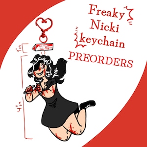 May include: A keychain featuring a cartoon character in a black dress with red blood splatters, holding two small objects. It has a red heart-shaped clasp and a rectangular tag labelled ONE WISH WILLOW. A ruler graphic indicates a 2.54 cm and 10.16 cm height.
