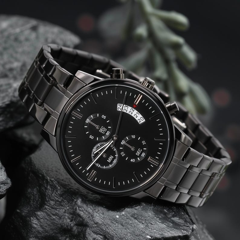 May include: A black wristwatch with a matching metal band. The watch face has multiple sub-dials and a date display. The watch is set against a dark, textured background, highlighting its sleek design.