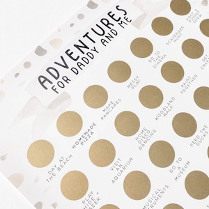 May include: A white card with gold circles containing activities for a father and child to do together. The card has the text "Adventures for Daddy and Me" at the top. Some of the activities include "Day at the Beach", "Homemade Pizza", "Make Pancakes", "Messy Play", "Go to the Cinema", "Scavenger Hunt", "Woodland Walk", "Paint Together", "Get Crafty", "Play Hide and Seek", "Visit an Aquarium", "Home Disco Dancing", "Go to a Museum", "Feed the Ducks", "Swimming Bath Ashes", "Musical Instruments", "Visit a Farm", and "Host a Puppet Show".