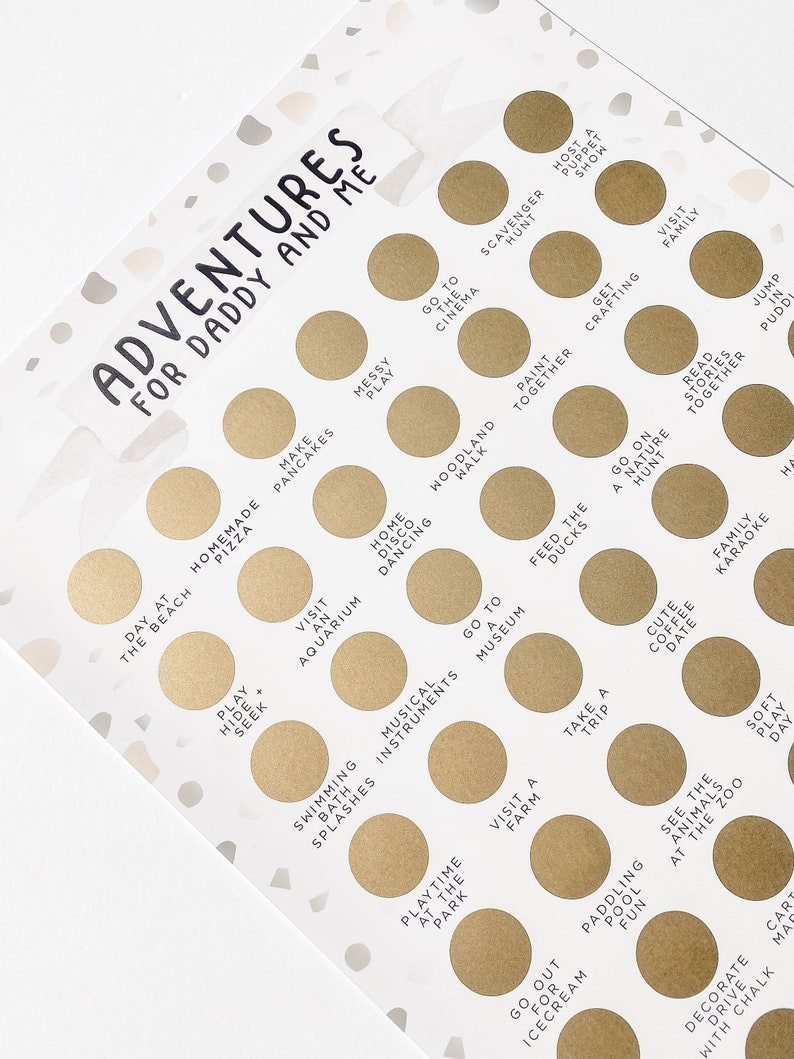 May include: A gold and white printable game card with the text "Adventures for Daddy and Me". The card features a grid of 25 circles, each containing a different activity for a father and child to do together. Some of the activities include "Make Pancakes", "Go to the Cinema", "Play Hide and Seek", "Visit an Aquarium", "Go on a Nature Hunt", "Feed the Ducks", "Take a Trip", "Decorate with Chalk", and "Jump in Puddles".