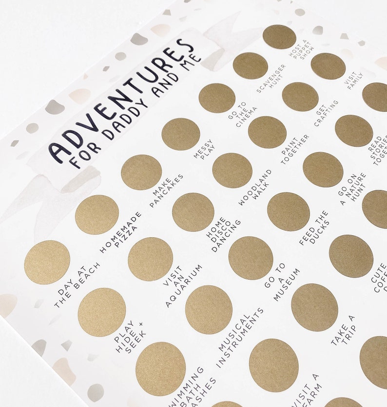 May include: A white card with gold circles and black text. The card has the title "Adventures for Daddy and Me" and lists activities like "Make Pancakes", "Visit an Aquarium", "Go to the Cinema", and "Feed the Ducks".