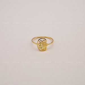 May include: A gold ring featuring a delicate, intricate design resembling a brain. The ring is simple and elegant, ideal for everyday wear.