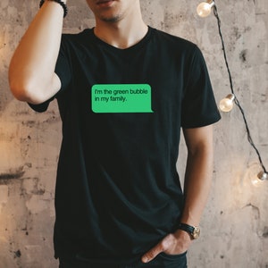 May include: A black t-shirt with a green text bubble that says "I'm the green bubble in my family."