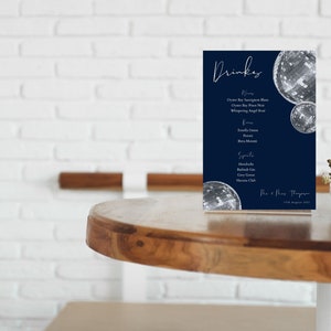 May include: A blue and white drinks menu with a disco ball design. The menu lists various drinks, including beer, wine, and spirits. The text at the bottom reads "The & Mrs. Thompson 7th August 2021."