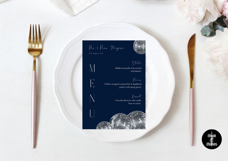 May include: A navy blue wedding menu card with white text. The menu includes a starter, main course, and dessert. The card is decorated with a silver disco ball graphic.