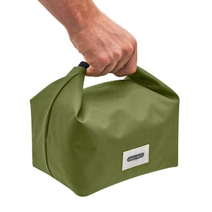 May include: A green canvas lunch bag with a black handle and a white label that says "Black + Blum" on it.