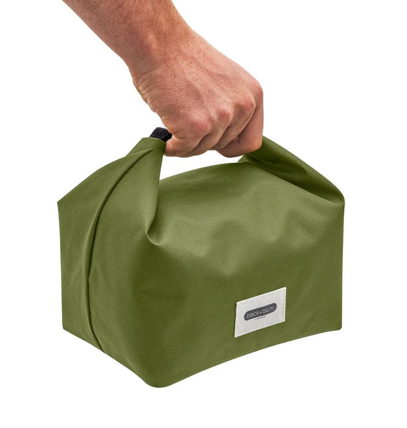 May include: A green canvas lunch bag with a black handle and a white label that says "Black + Blum" on it.