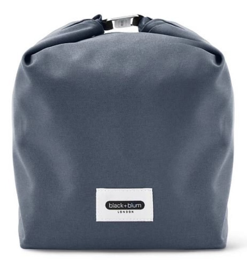 May include: A dark blue canvas tote bag with a black and white label that reads "black+blum LONDON".