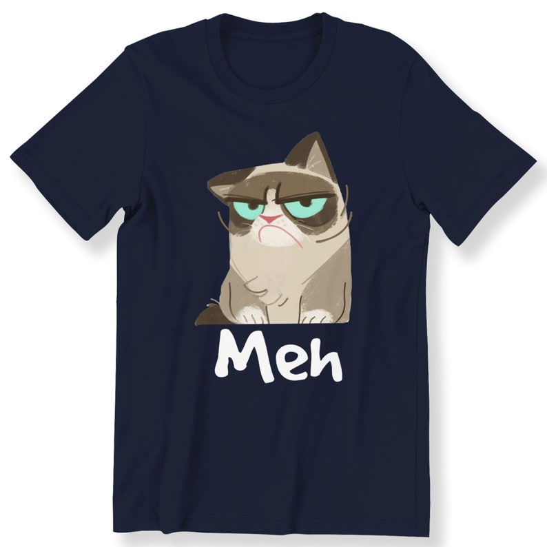 May include: A navy blue t-shirt featuring a cartoon image of a grumpy cat with the word "Meh" printed beneath it.