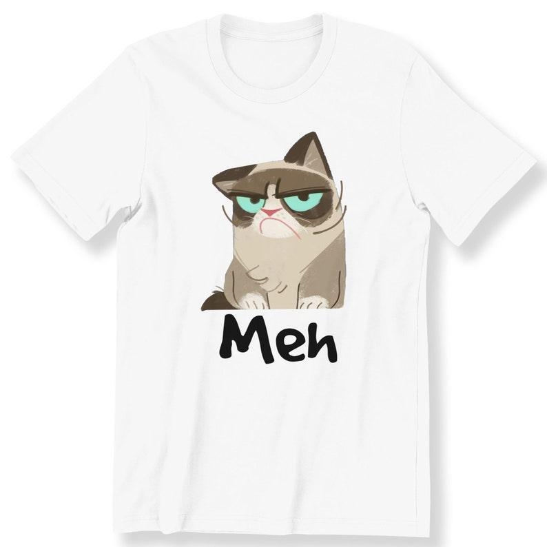 May include: White t-shirt featuring a cartoon image of a grumpy cat with the word "Meh" printed beneath it.