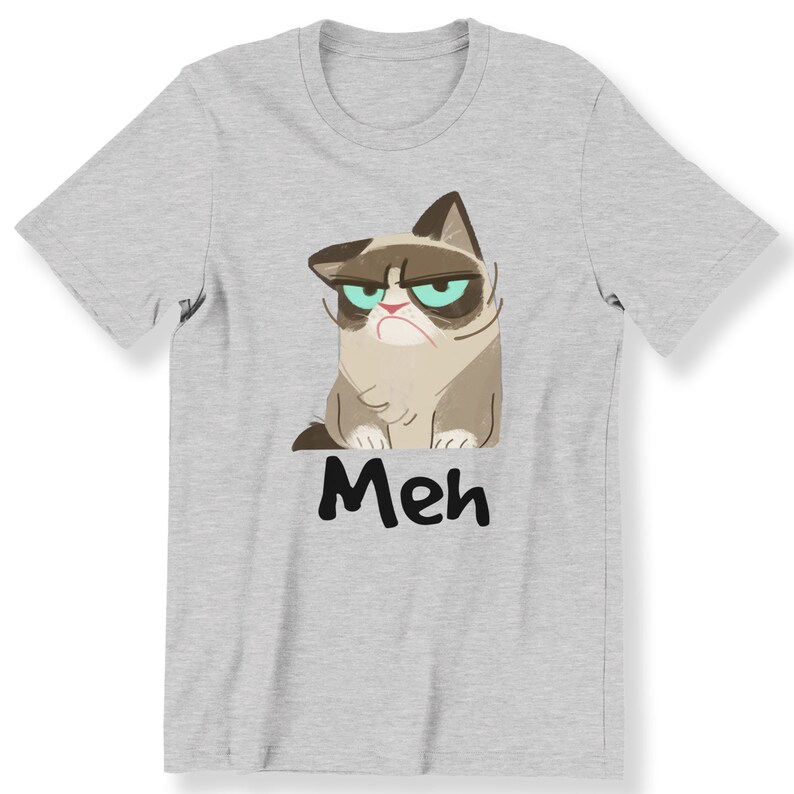 May include: A grey t-shirt featuring a cartoon image of a grumpy cat with the word "Meh" printed beneath it.