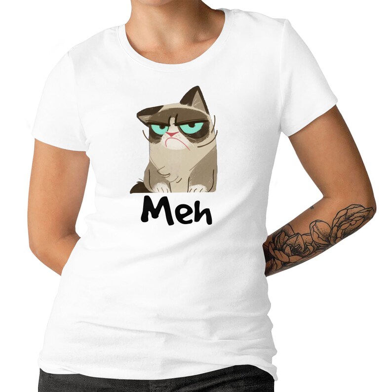 May include: White t-shirt featuring a cartoon image of a grumpy cat with the word "Meh" printed beneath it.