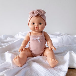 Goldie | Baby Girl with Blonde Hair Blue eyes and Blush Romper and Headband